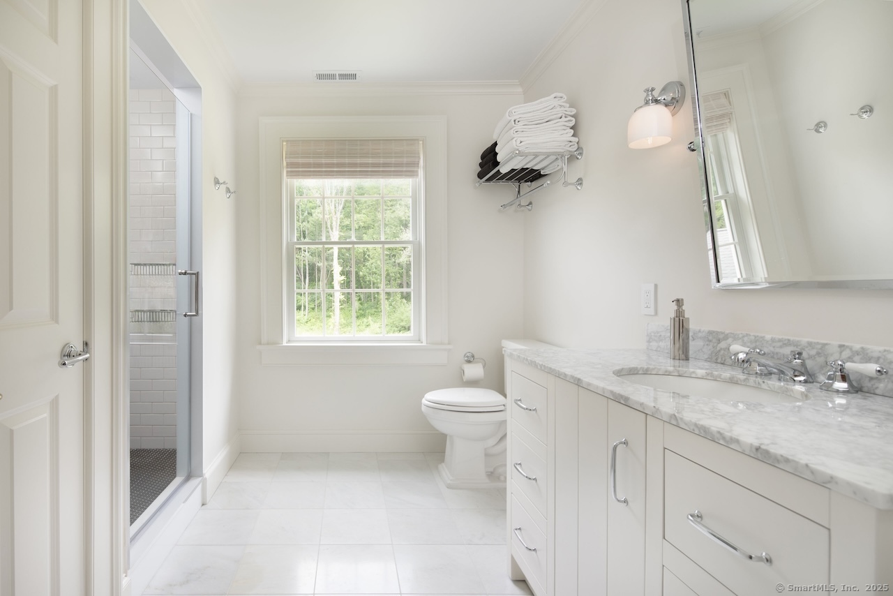 200 Sharon Mountain Road Sharon, CT 06069 - Photo 22 of 29 a bathroom with a granite countertop sink a toilet and a window