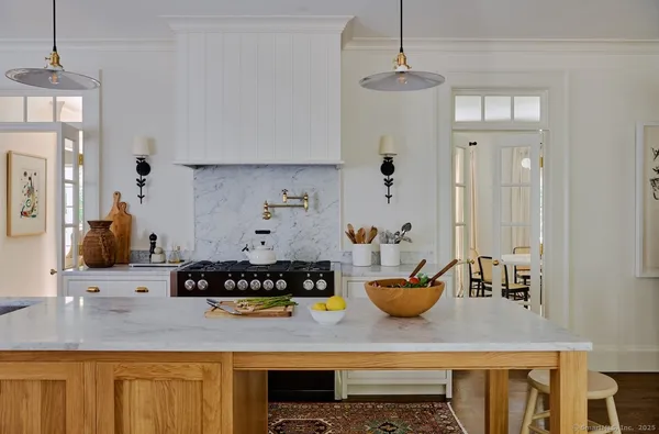 a kitchen with a refrigerator a stove and white cabinets