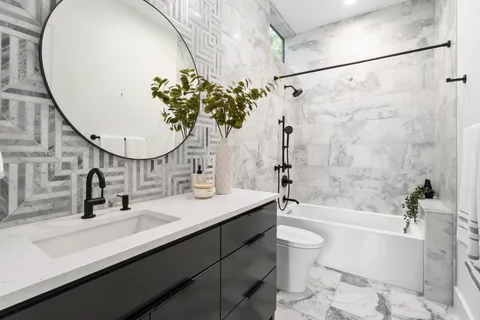 a bathroom with a sink a toilet and a mirror