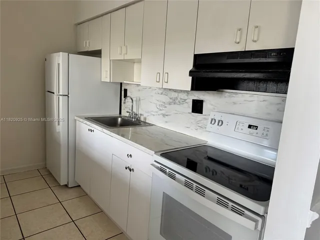 a kitchen with appliances and cabinets
