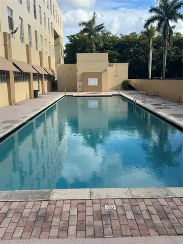 a view of a swimming pool with a yard