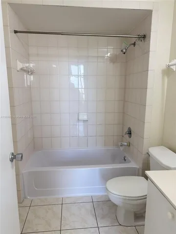 a bathroom with a bathtub and a toilet