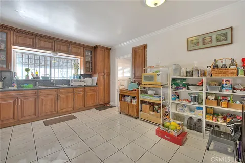 a large kitchen with stainless steel appliances cabinets and a large window
