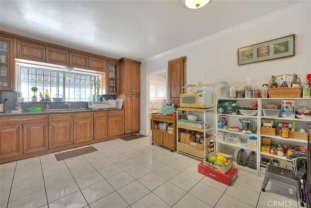 a large kitchen with stainless steel appliances cabinets and a large window