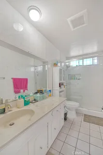 a bathroom with a sink a toilet and a shower