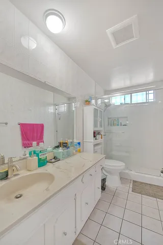 a bathroom with a sink a toilet and a shower