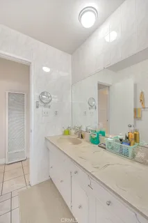 a spacious bathroom with a granite countertop sink and a mirror