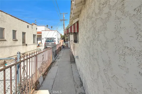 a view of a street with brick wall