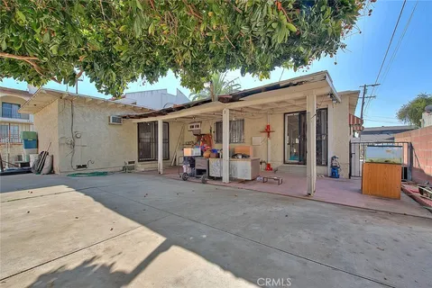 a view of a patio with table and chairs under an umbrella