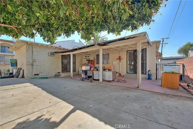 a view of a patio with table and chairs under an umbrella