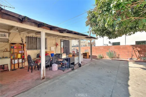 a group of people sitting in front of retail shop