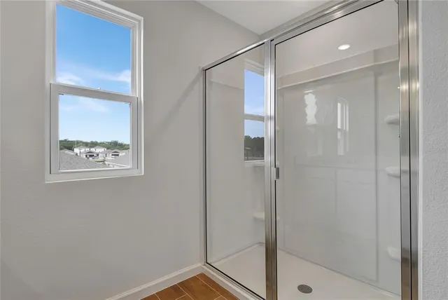 a bathroom with a glass shower door