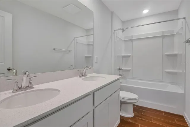a bathroom with a sink toilet tub and shower