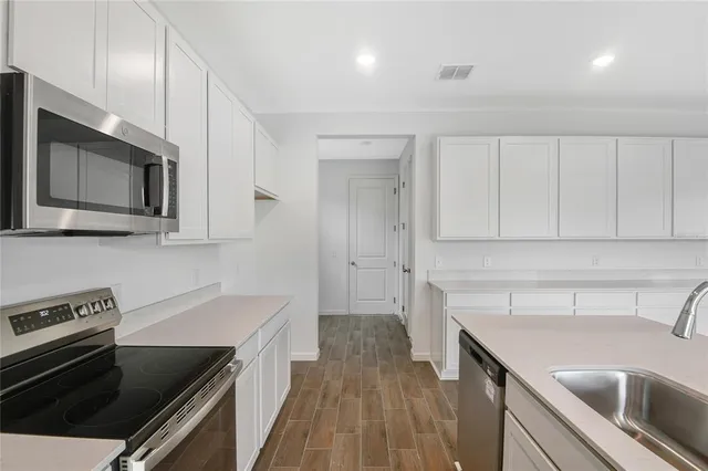 a kitchen with a sink stove and microwave