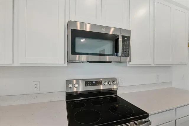 a kitchen with a stove and a microwave