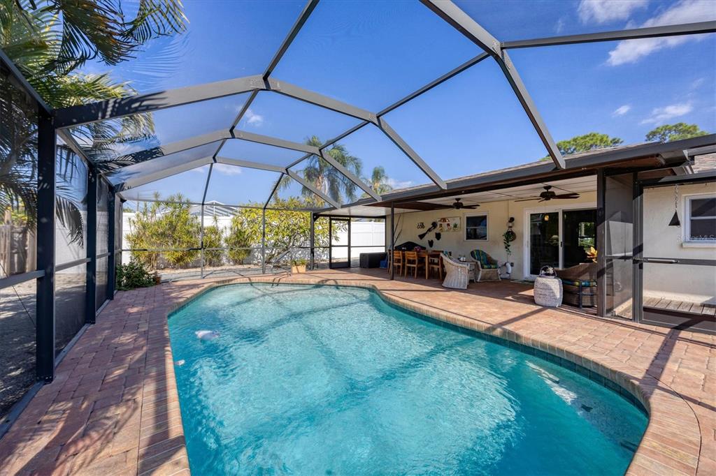 a view of a backyard with swimming pool