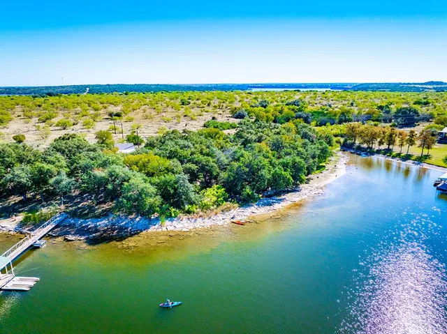 an aerial view of a houses with ocean view
