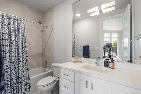 a kitchen with stainless steel appliances granite countertop a table chairs sink and cabinets