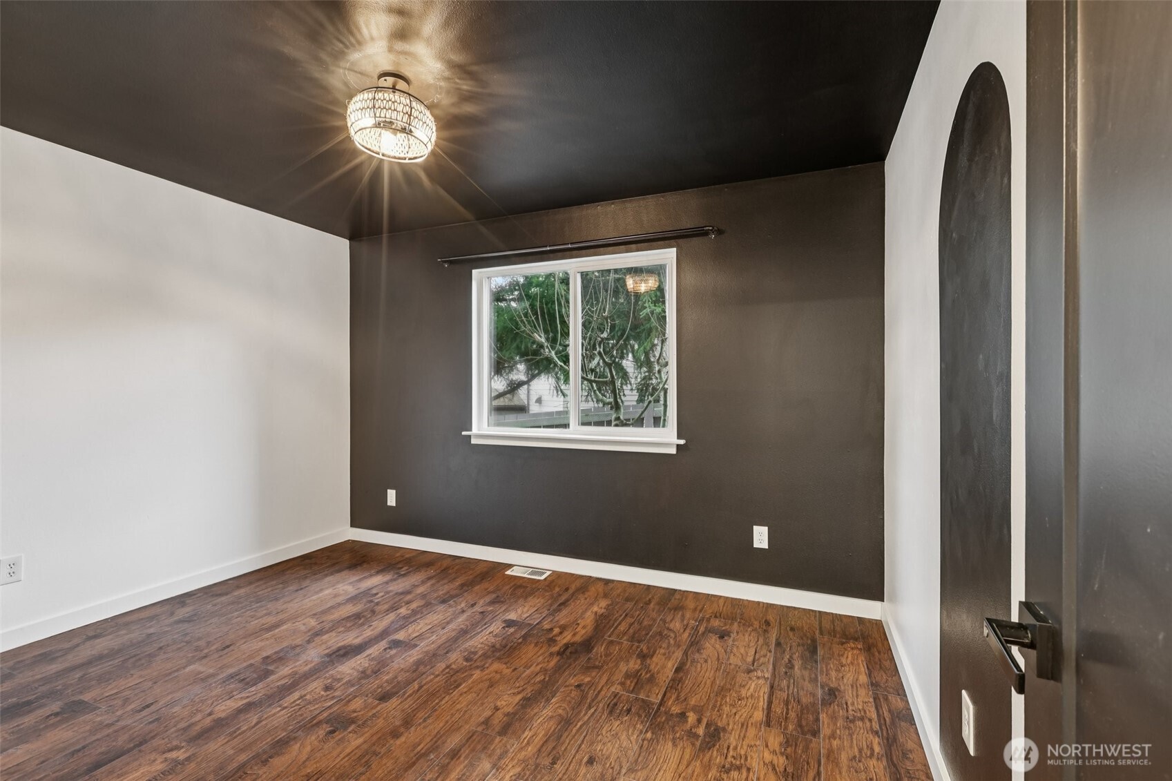 2210 Grade Road, Unit 7 Lake Stevens, WA 98258 - Photo 16 of 27 an empty room with wooden floor chandelier fan and windows