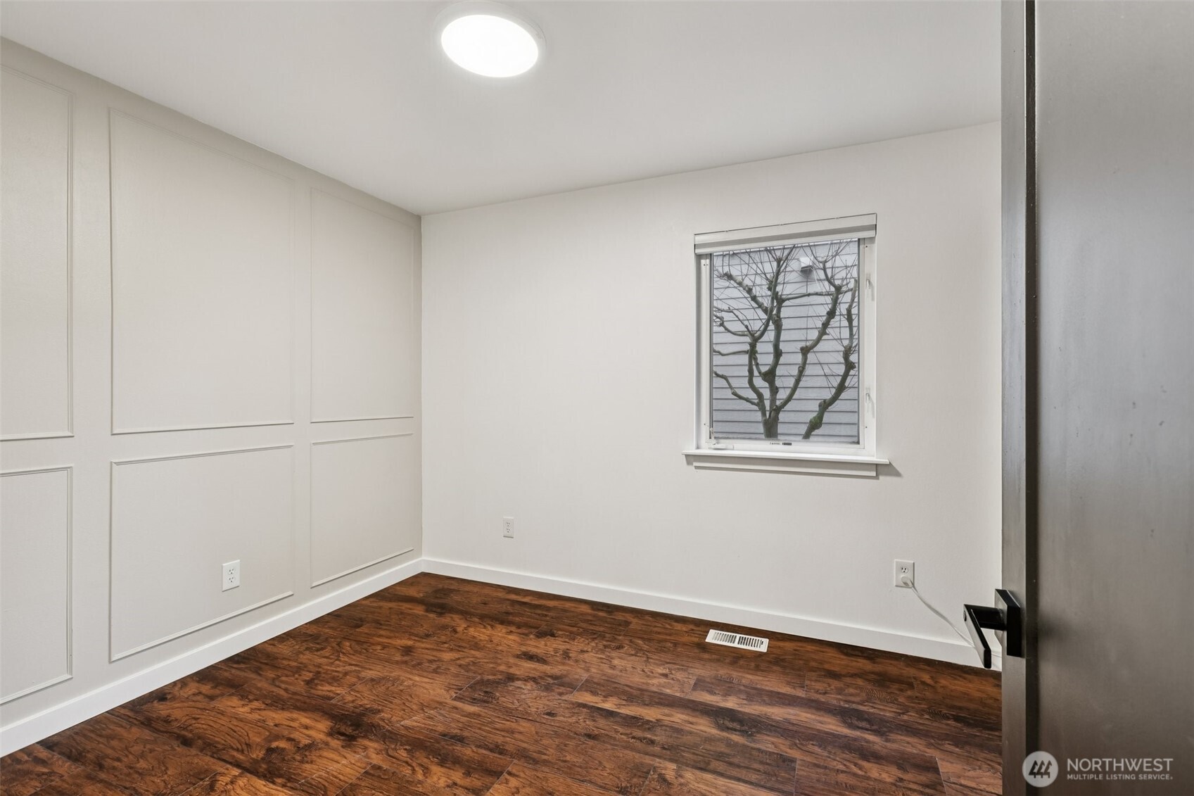 2210 Grade Road, Unit 7 Lake Stevens, WA 98258 - Photo 20 of 27 a view of an empty room with wooden floor and a window