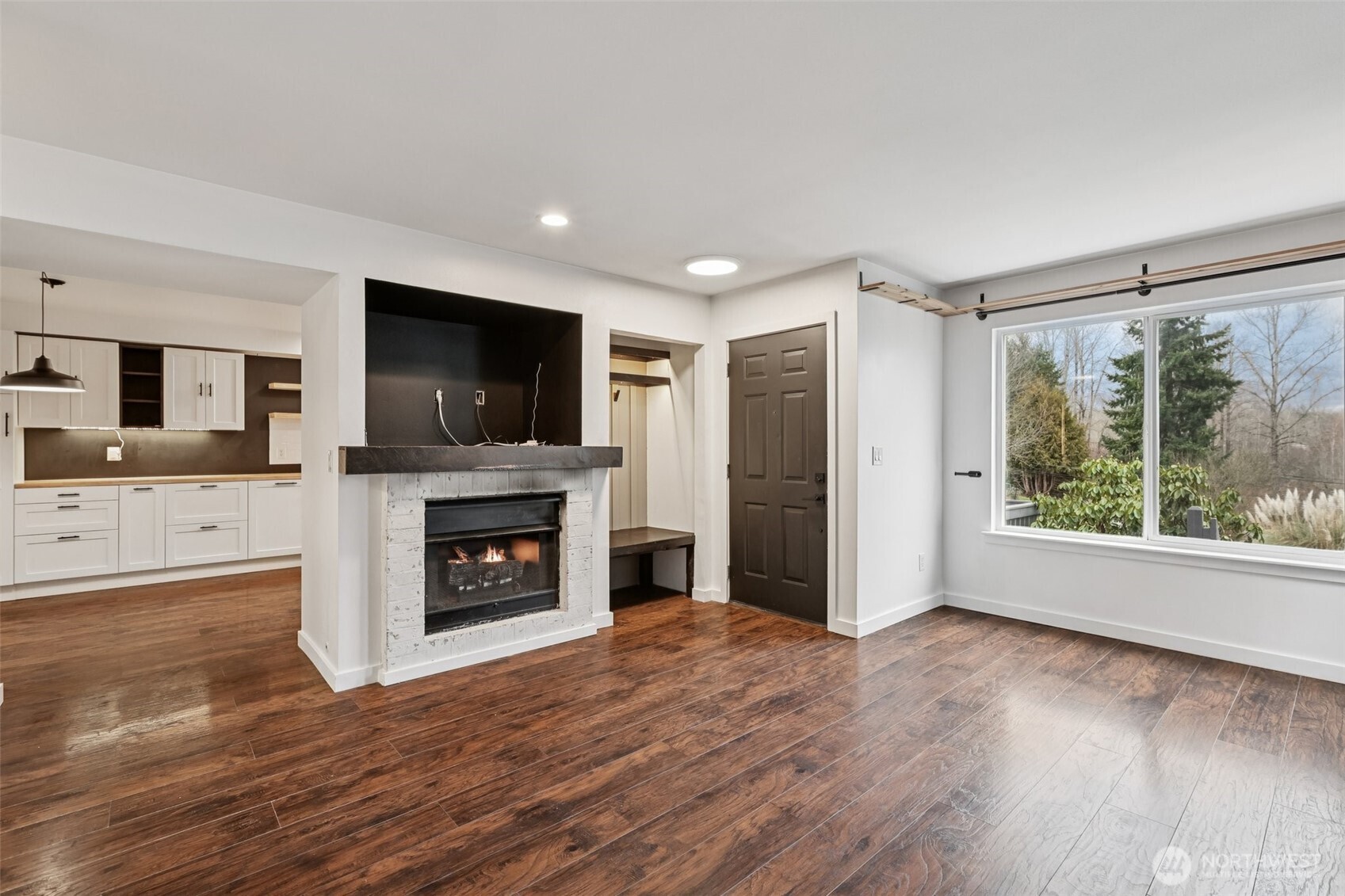 2210 Grade Road, Unit 7 Lake Stevens, WA 98258 - Photo 2 of 27 a view of a livingroom with a fireplace wooden floor and window