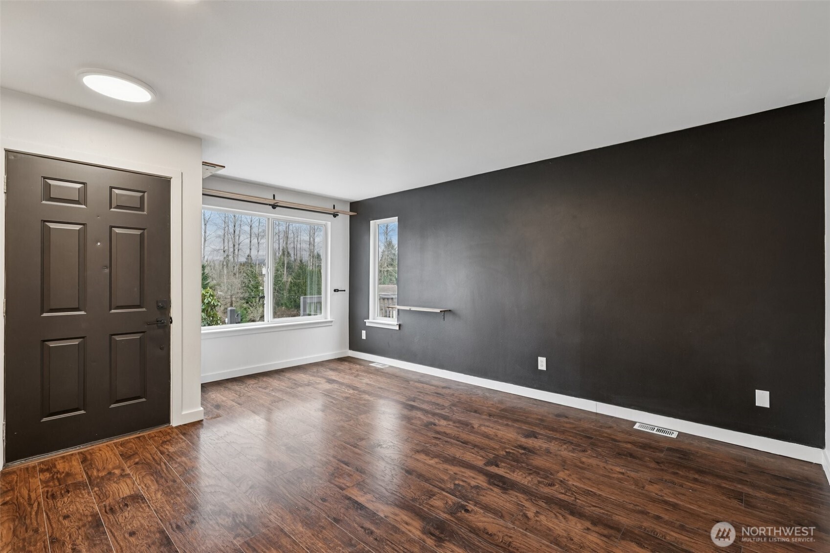 2210 Grade Road, Unit 7 Lake Stevens, WA 98258 - Photo 5 of 27 a view of an empty room with wooden floor and a window