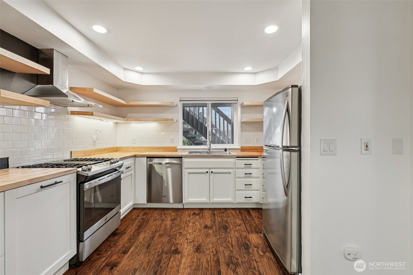 2210 Grade Road, Unit 7 Lake Stevens, WA 98258 - Photo 6 of 27 a kitchen with white cabinets and stainless steel appliances