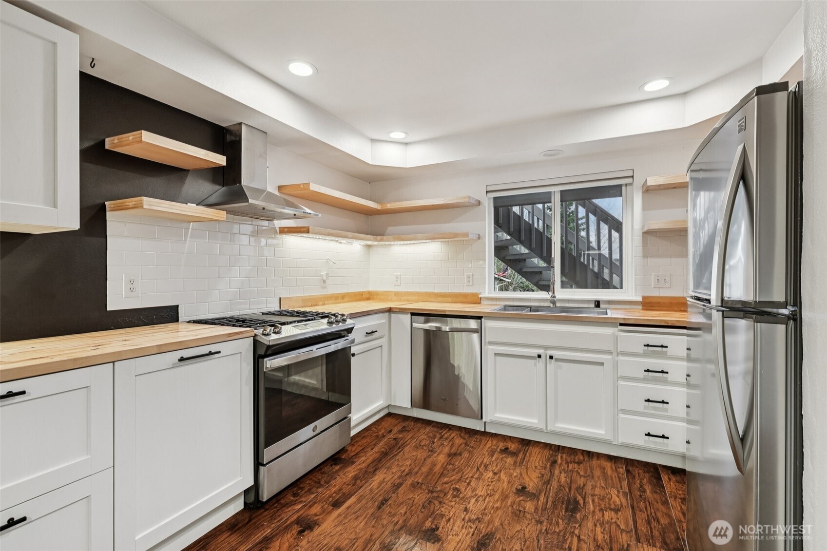 2210 Grade Road, Unit 7 Lake Stevens, WA 98258 - Photo 7 of 27 a kitchen with granite countertop a sink stainless steel appliances and cabinets