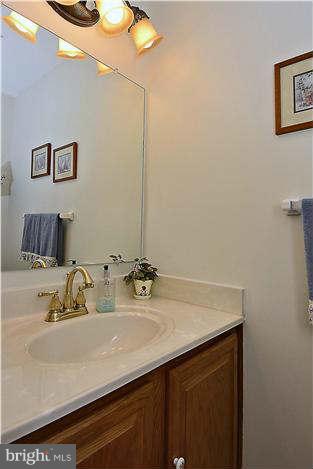 8102 Walton Road Severn, MD 21144 - Photo 14 of 30 a bathroom with a sink and a mirror