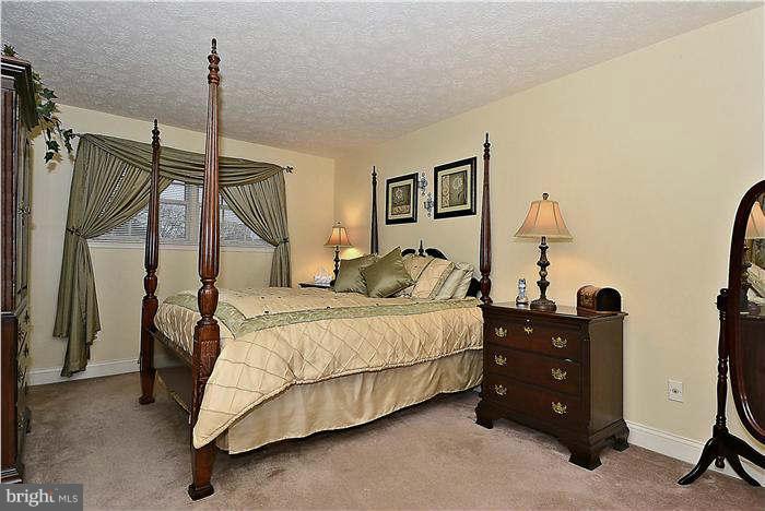 8102 Walton Road Severn, MD 21144 - Photo 15 of 30 a bedroom with a bed and a table