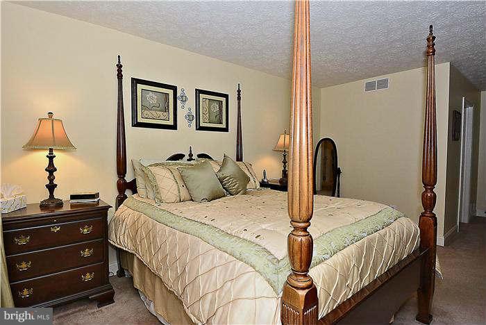 8102 Walton Road Severn, MD 21144 - Photo 16 of 30 a bedroom with a bed and a dresser