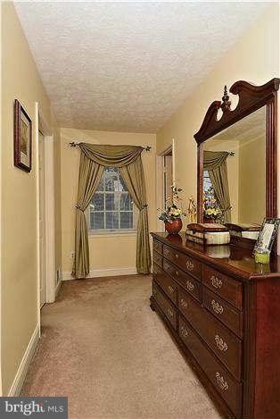 8102 Walton Road Severn, MD 21144 - Photo 17 of 30 a room with a bed and a mirror on dresser