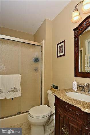 8102 Walton Road Severn, MD 21144 - Photo 18 of 30 a bathroom with a granite countertop sink toilet and shower
