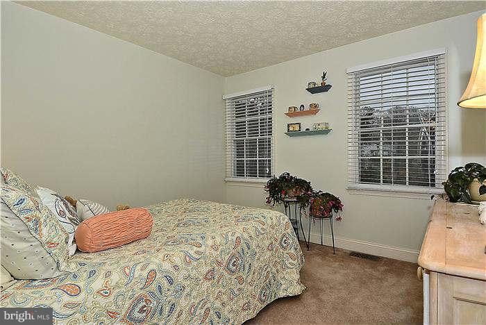 8102 Walton Road Severn, MD 21144 - Photo 21 of 30 a bedroom with a bed and a window