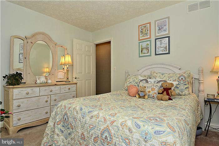 8102 Walton Road Severn, MD 21144 - Photo 22 of 30 a bedroom with a bed and a dresser
