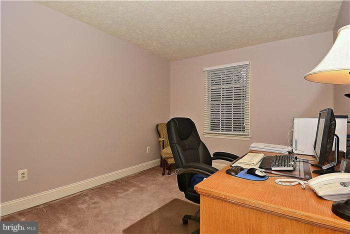 8102 Walton Road Severn, MD 21144 - Photo 23 of 30 a view of a workspace with furniture and a window
