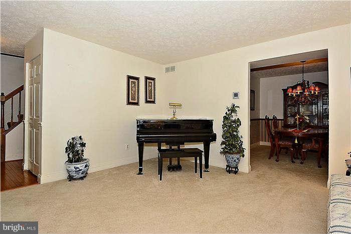 8102 Walton Road Severn, MD 21144 - Photo 4 of 30 a living room with furniture and a piano