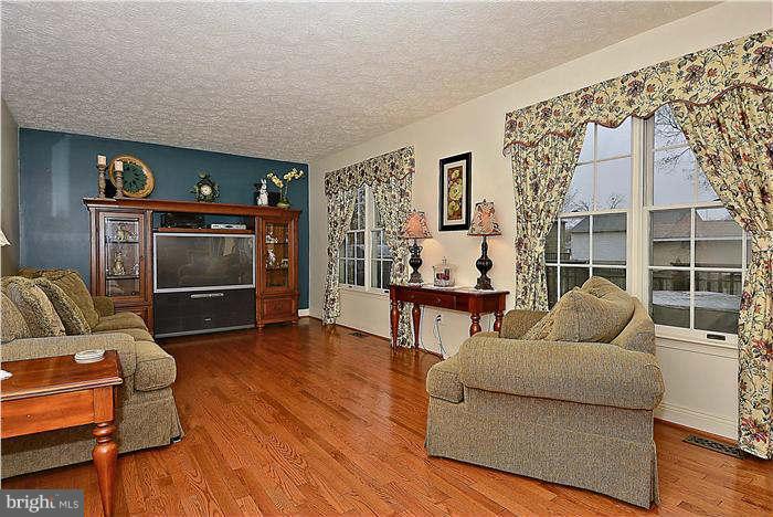 8102 Walton Road Severn, MD 21144 - Photo 6 of 30 a living room with furniture and a flat screen tv