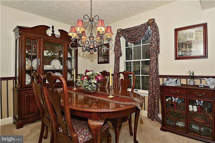 8102 Walton Road Severn, MD 21144 - Photo 8 of 30 a view of a dining room with furniture and chandelier