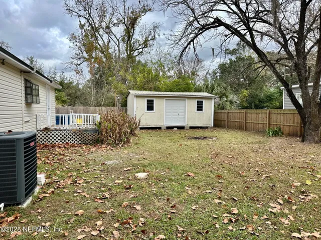 a front view of house with yard and trees
