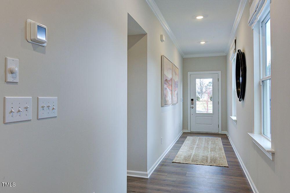 408 Carpels Drive Wendell, NC 27591 - Photo 6 of 31 a view of hallway with window and wooden floor