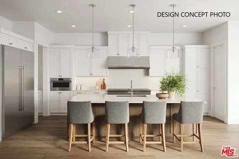 a kitchen with stainless steel appliances kitchen island granite countertop a table and chairs in it