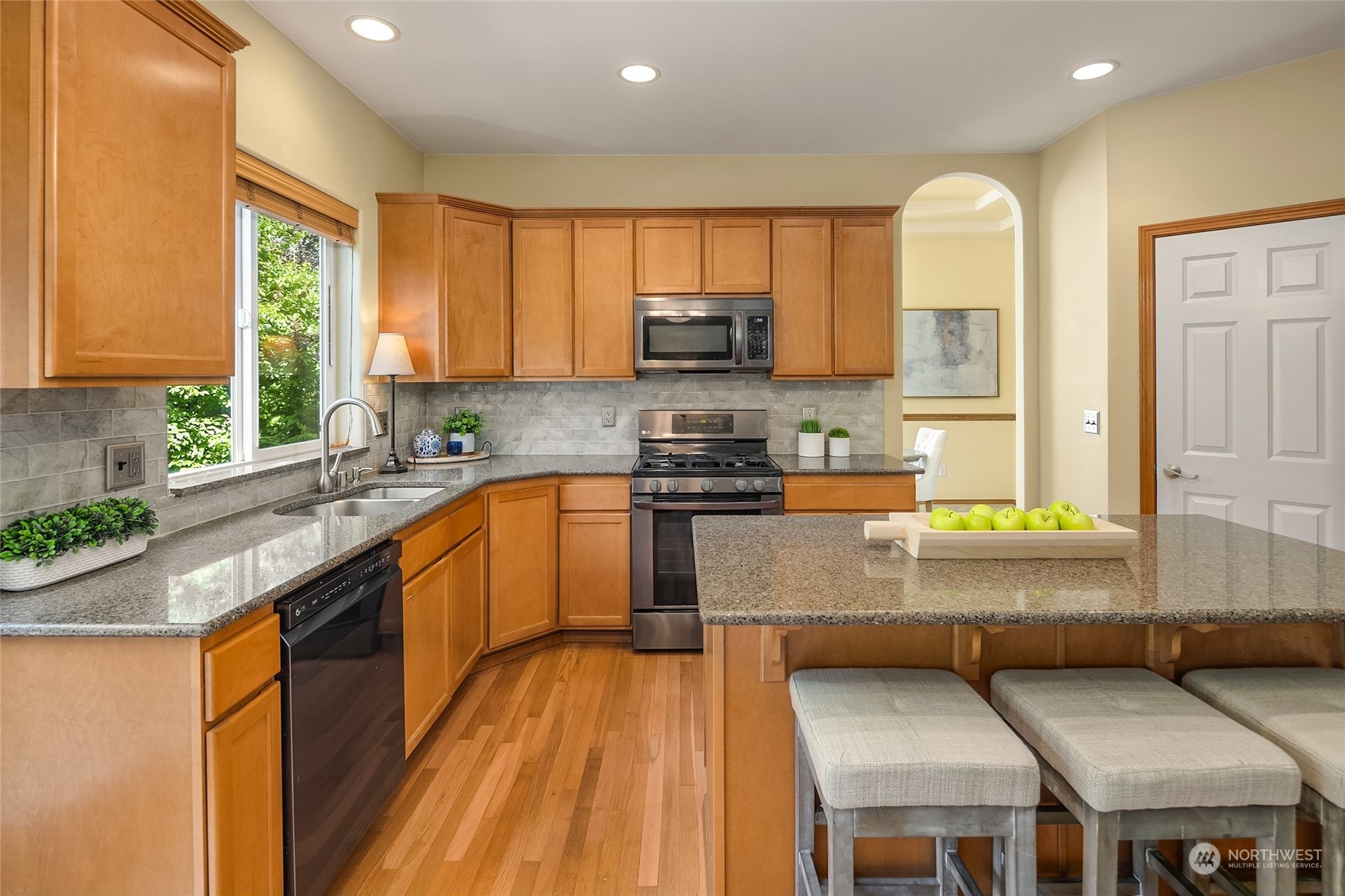 307 197th Place Southwest Bothell, WA 98012 - Photo 12 of 30 a kitchen with stainless steel appliances granite countertop a stove a sink and a microwave