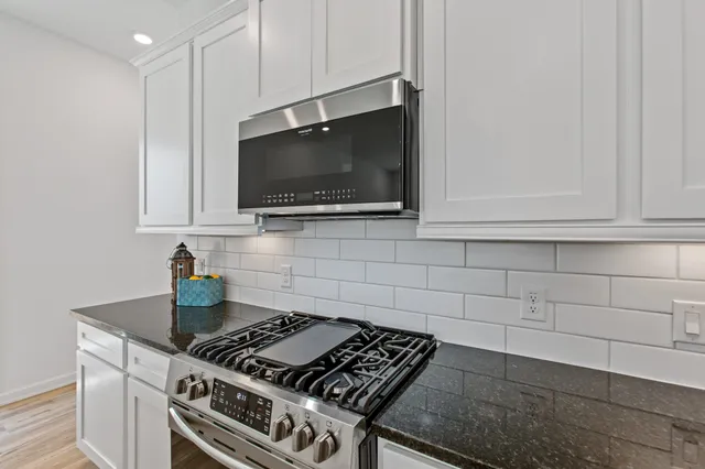 a kitchen with a stove and a microwave