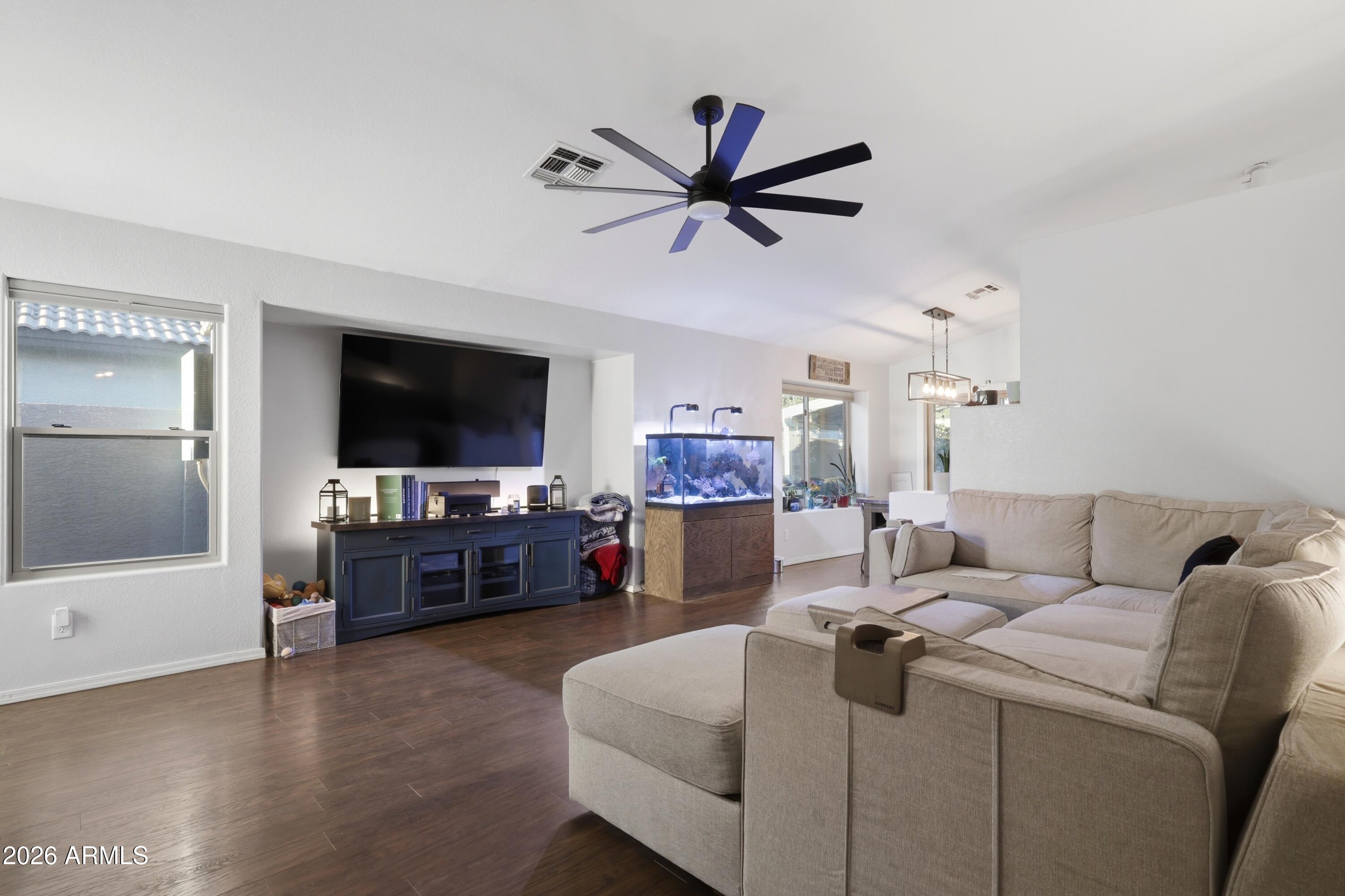 661 North Joshua Tree Lane Gilbert, AZ 85234 - Photo 6 of 47 a living room with furniture and a flat screen tv