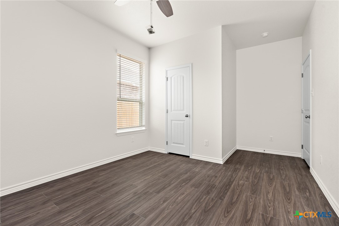 5219 Rose Gdn Loop Killeen, TX 76542 - Photo 20 of 24 an empty room with wooden floor and windows