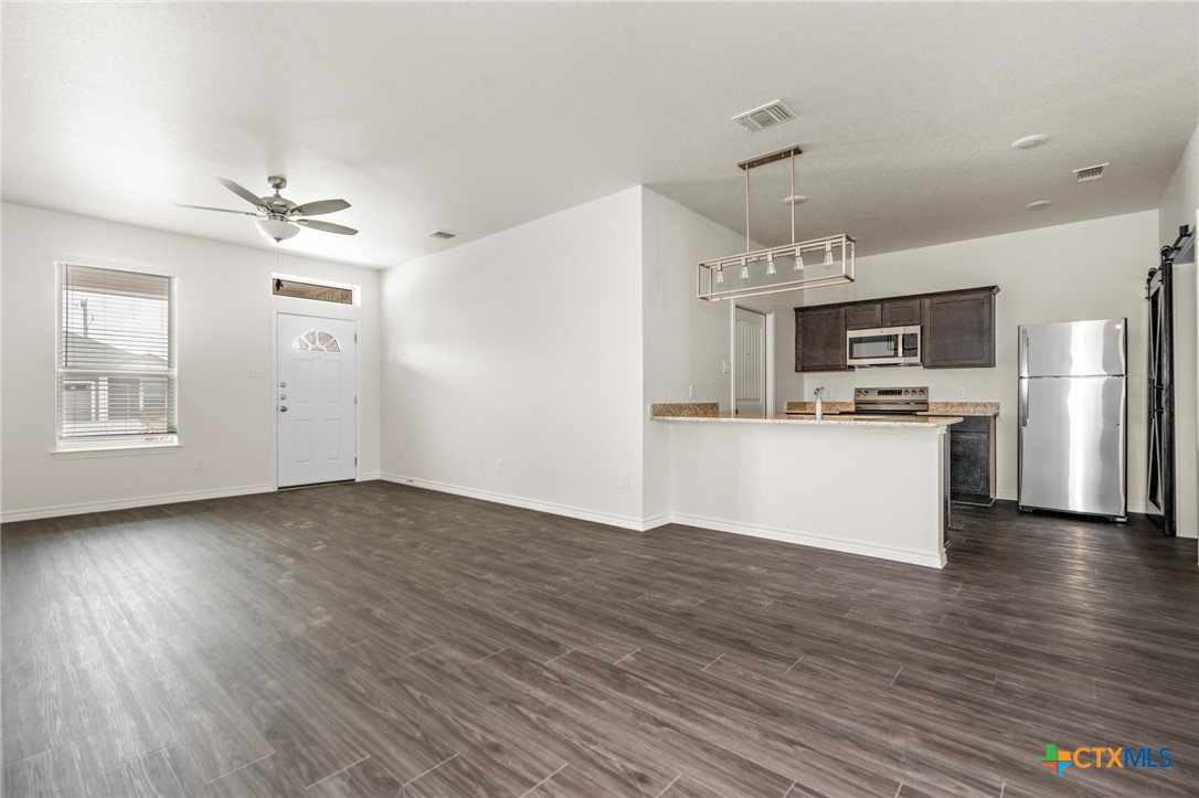 5219 Rose Gdn Loop Killeen, TX 76542 - Photo 6 of 19 a view of a kitchen with a sink a refrigerator and a stove top oven
