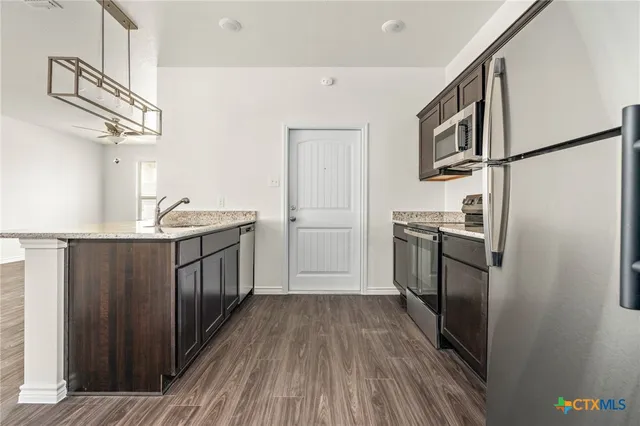 a kitchen with a refrigerator a sink and dishwasher