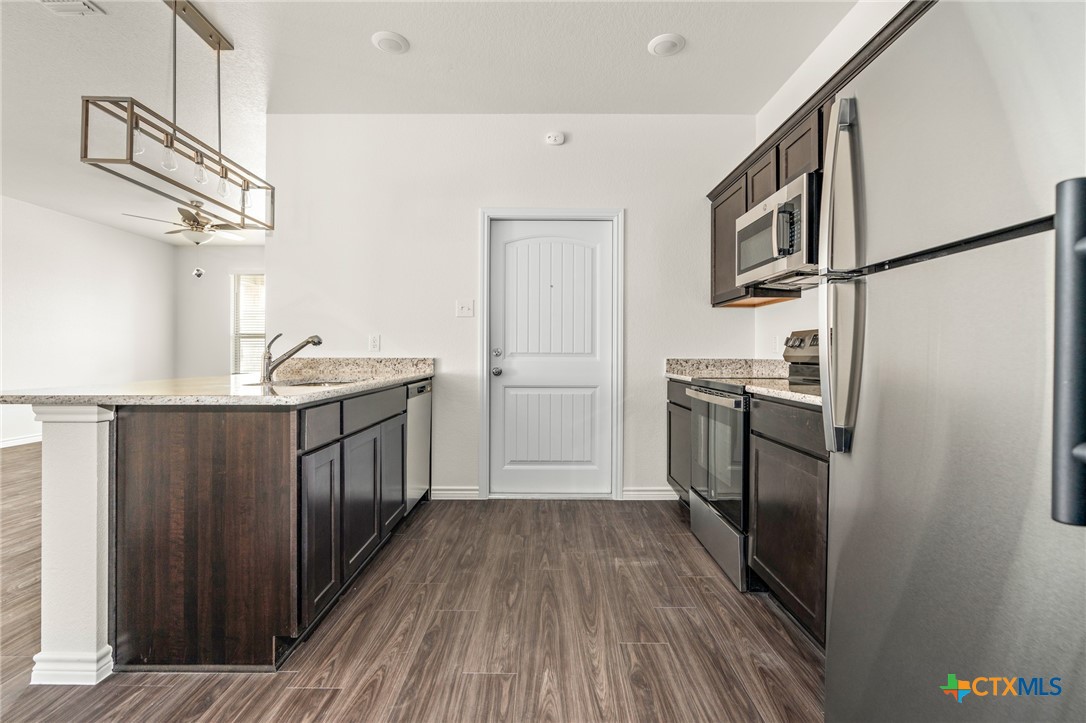5219 Rose Gdn Loop Killeen, TX 76542 - Photo 8 of 19 a kitchen with a refrigerator a sink and dishwasher