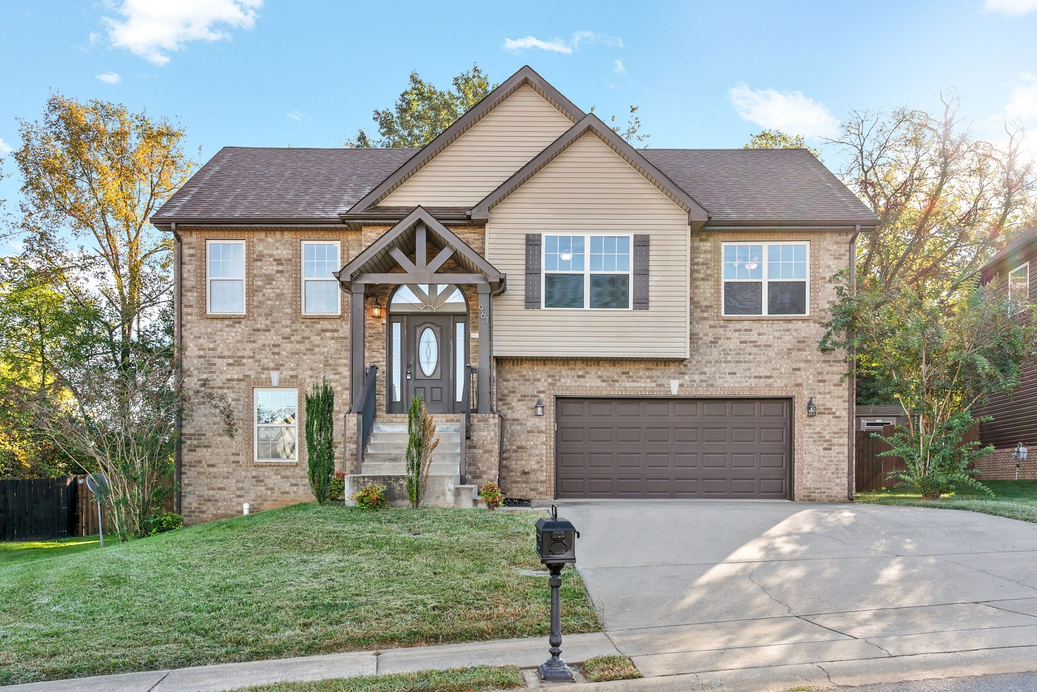 a front view of a house with a yard and garage